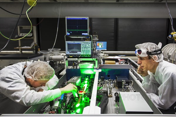 PhD student during his research work adjusting his experimental setup