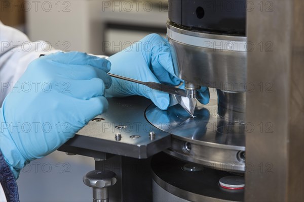 Scientists during their research work on a tablet press at the Institute for Pharmaceutical Technology and Biopharmacy at Heinrich-Heine-University Duesseldorf