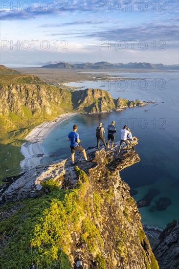 Four hikers standing on rocky outcrop