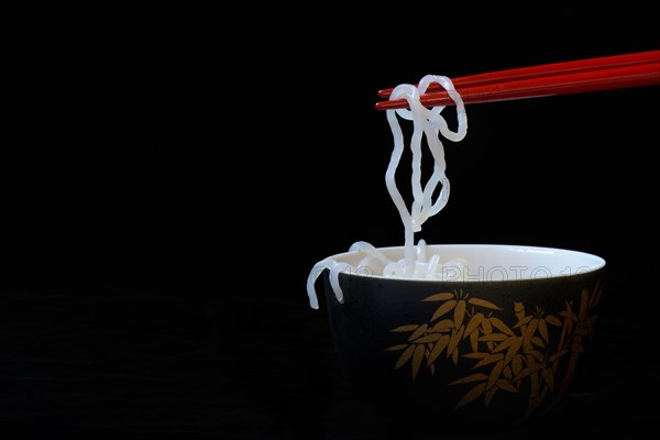 Shirataki noodles made from konjac flour on chopsticks