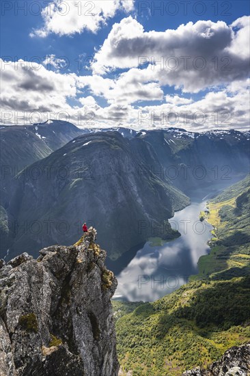 Hiker standing on rocky outcrop