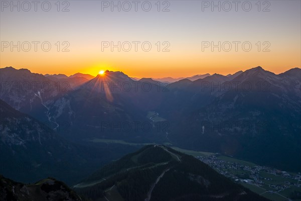 Last rays of sun over mountain landscape at sunset