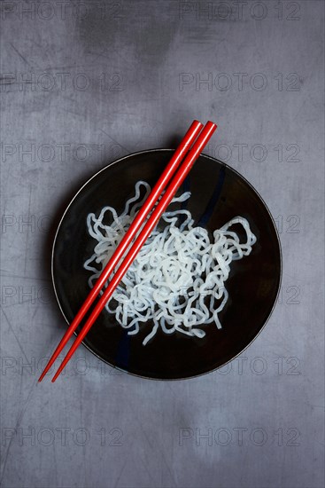 Shirataki noodles made from konjac flour in a bowl with chopsticks