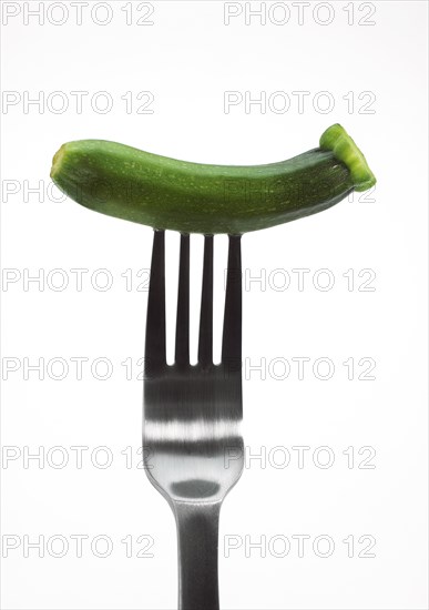MINIATURE ZUCCHINI OR LONG ZUCCHINI IN MINIATURE AGAINST A WHITE BACKGROUND