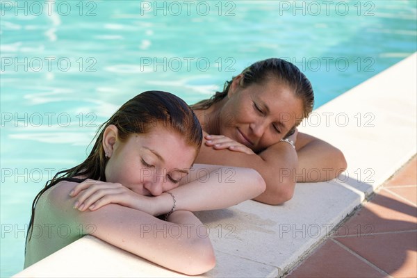 Woman with daughter at pool