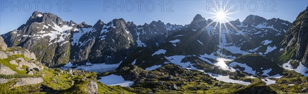 Sun shining on mountains with snow