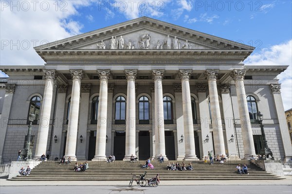 People sunbathing in front of the opera