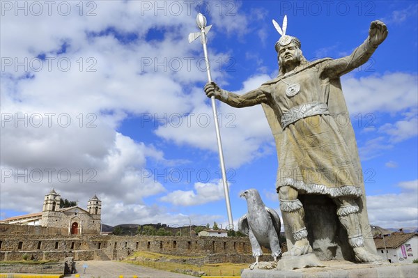 Statue of the Inca Pachacutec in front of sun temple with attached cathedral from the colonial period