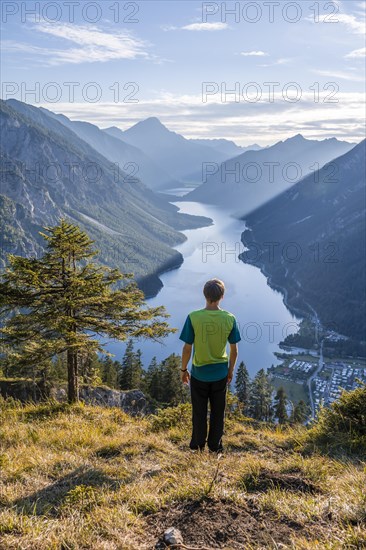 Hiker looks at Plansee