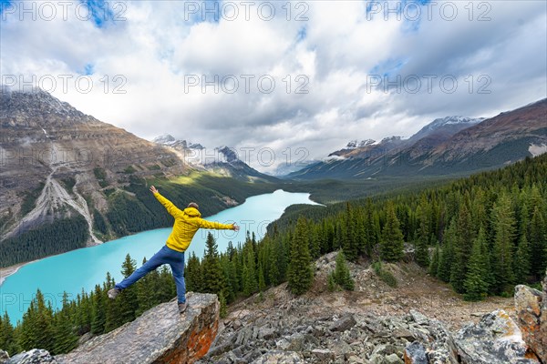 Hiker stretches his arms in the air