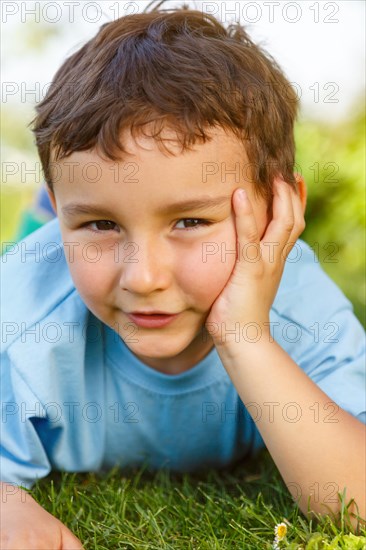 Child little boy portrait thinking looking meadow outside