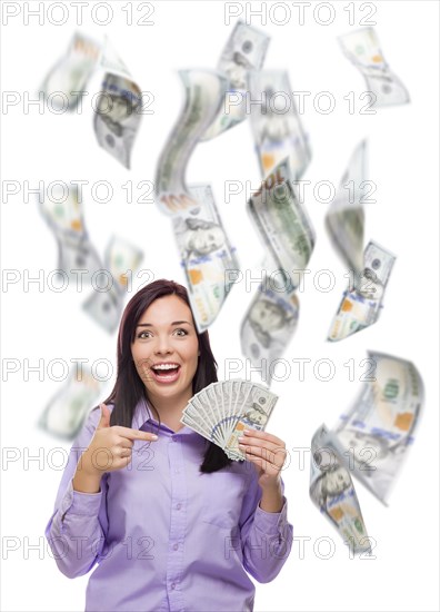 Celebrating young woman holding $100 bills with many others falling around her on white