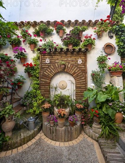 Fountain in the courtyard decorated with flowers