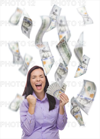 Celebrating young woman holding $100 bills with many others falling around her on white