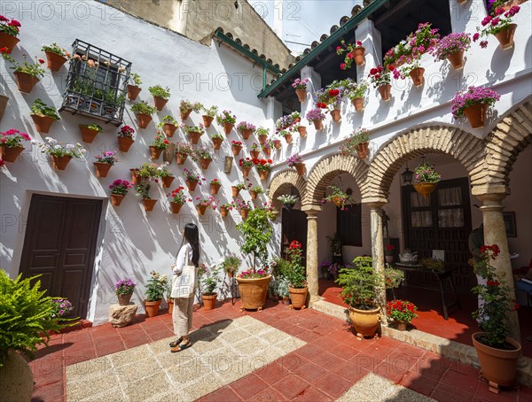 Young woman standing in a courtyard decorated with flowers