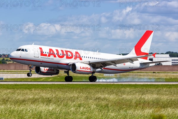 A Lauda Airbus A320 aircraft with registration number OE-LOY lands at Stuttgart Airport