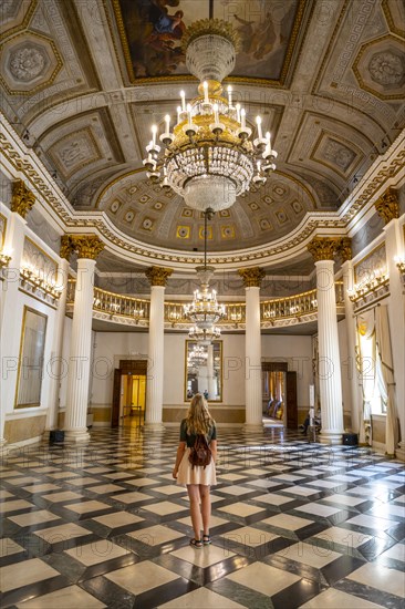 Young woman in a magnificent entrance hall