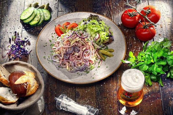 Swiss sausage salad with cheese and onion rings