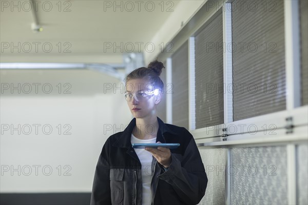 Young logistician working with scan glasses