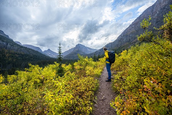 Hikers on a trail through mountain landscape