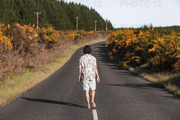Guy walking on a road