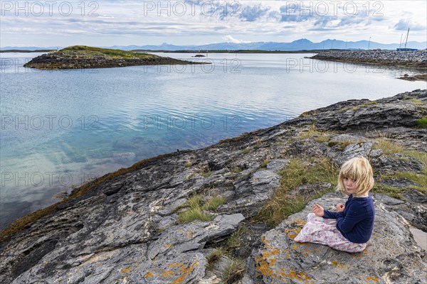 Little girl on a rock