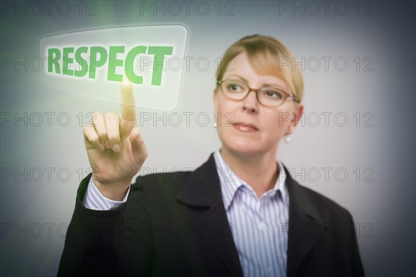 Attractive blonde woman pushing respect button on an interactive touch screen