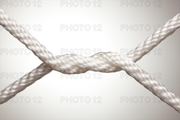 Nylon rope knot on a spot lit background