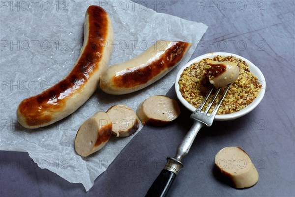 Sliced bratwurst and skin with Dijon mustard