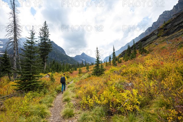 Hikers on a trail through mountain landscape
