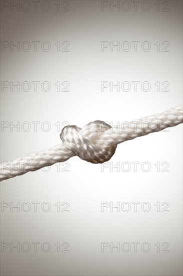Nylon rope knot on a spot lit background