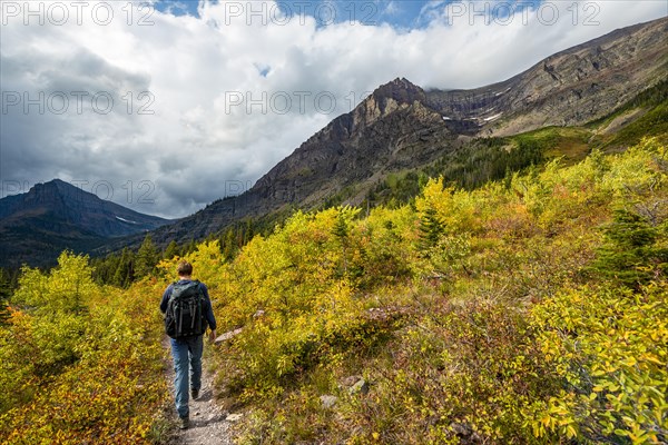 Hikers on a trail through mountain landscape