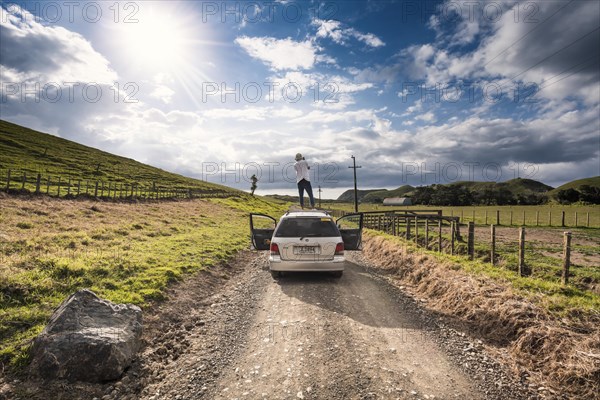 Guy on car roof with camera