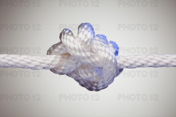 Nylon rope knot on a spot lit background