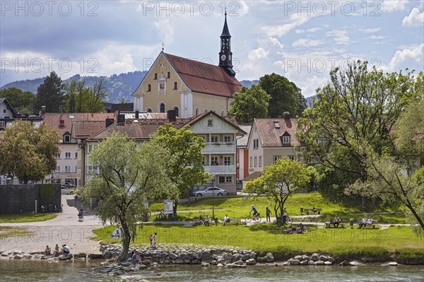 Isar bank with people and Franciscan church