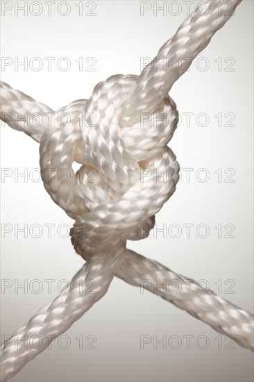 Nylon rope knot on a spot lit background