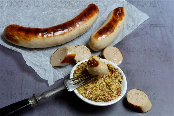 Sliced bratwurst and skin with Dijon mustard