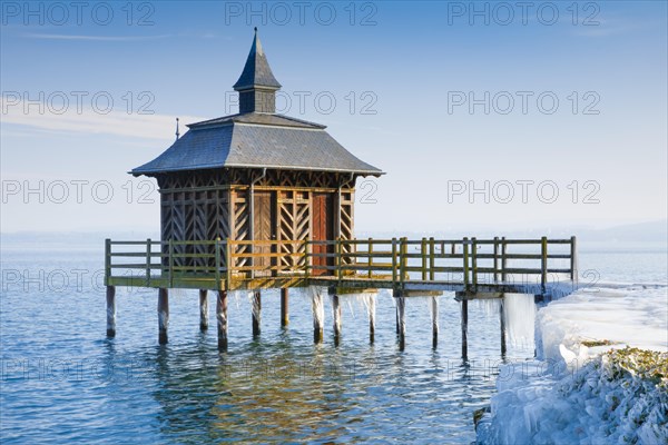 Iced wooden bathhouse on Lake Neuchatel in Gorgier