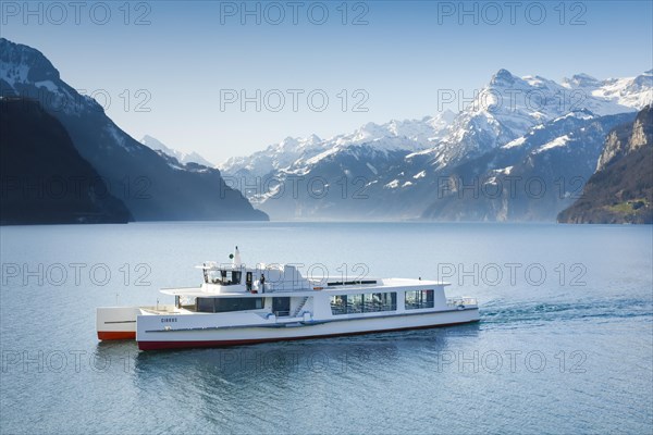 View from Brunnen on a boat on the Lake of Uri in front of the mountain scenery of the Alps of Uri