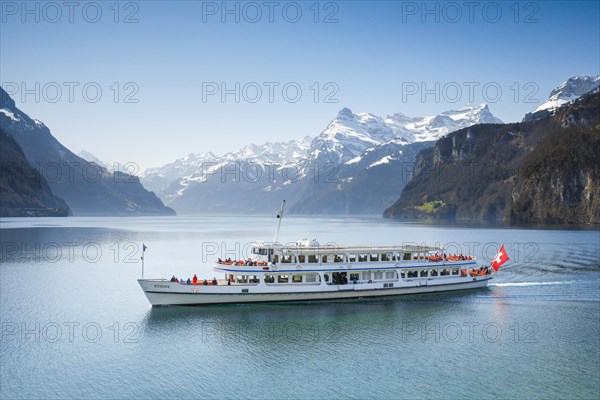 View from Brunnen on a boat on the Lake of Uri in front of the mountain scenery of the Alps of Uri