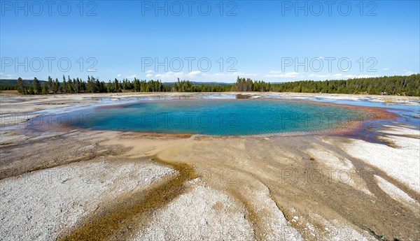 Steaming hot spring with colored mineral deposits