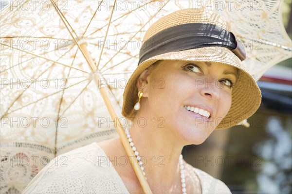 Beautiful 1920s dressed girl with parasol portrait