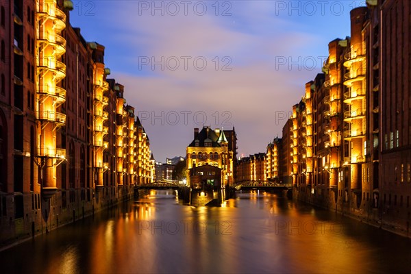 Moated castle Speicherstadt castle by night in Hamburg