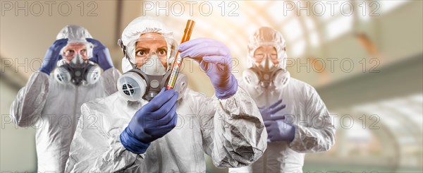 Team of doctors or nurses in hazmat gear holding positive coronavirus test tube banner