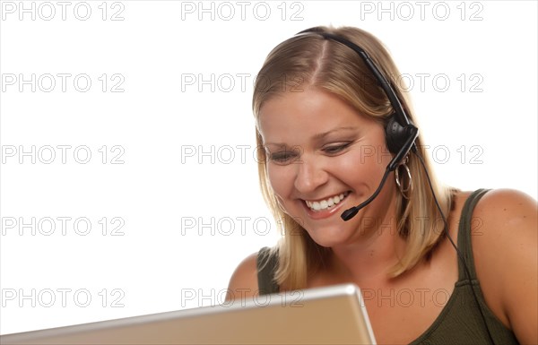 Beautiful friendly female customer support phone operator in front of a computer screen isolated on a white background