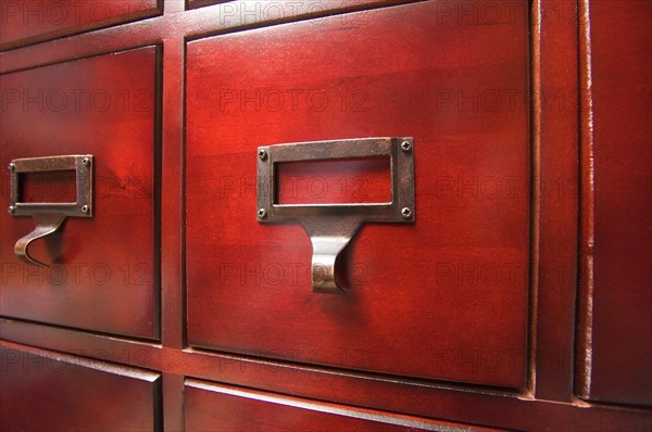 Lustrous wooden card file cabinet in dramatic light