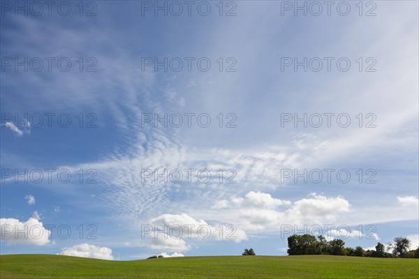 Hilly landscape and cirrus clouds in the sky