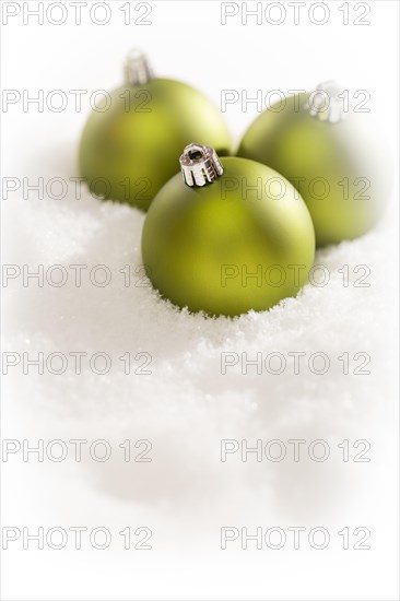 Beautiful matt green christmas ornaments on snow flakes room for your own text