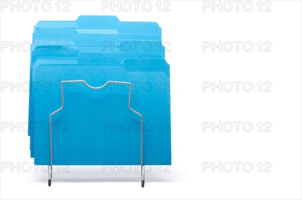 Blue file folders in rack isolated on a white background. labels ready for your own text
