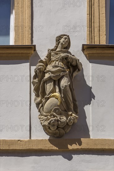 Sculpture of Maria immaculata on a residential house